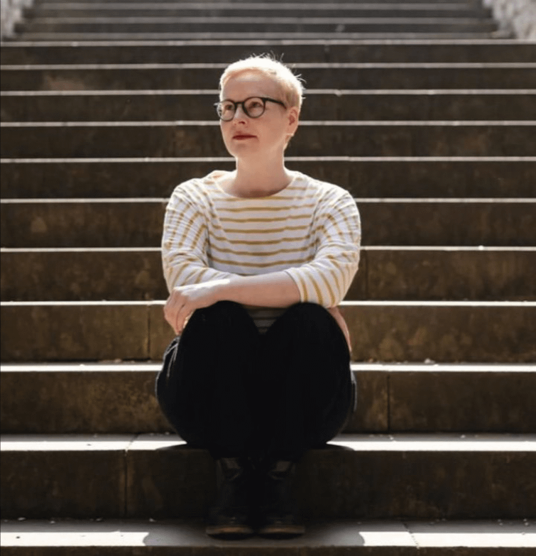 Photo of Shona sitting on some steps.